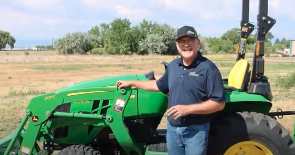 Neil Motley beside the 3025E tractor